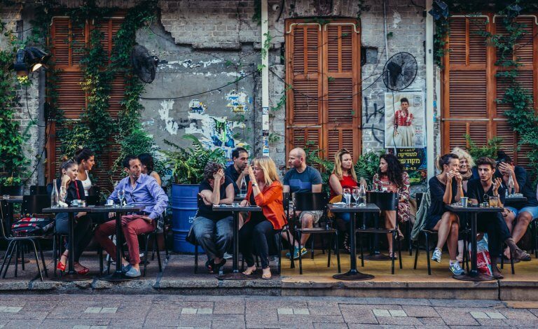 People sitting at tables outside th restaurant on Rothschild Boulevard bigstock--138283181