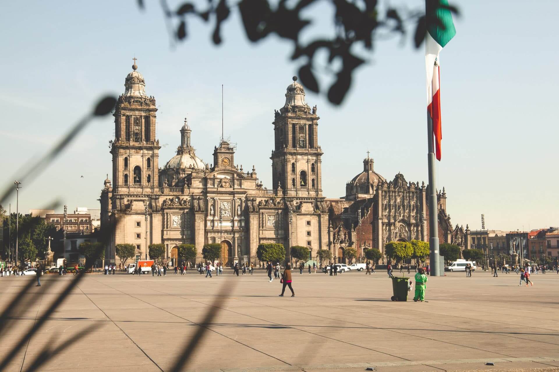 Zocalo Mexico City Jewish heritage tour. Mexican plaza with a large government building and the Mexican flag in front.