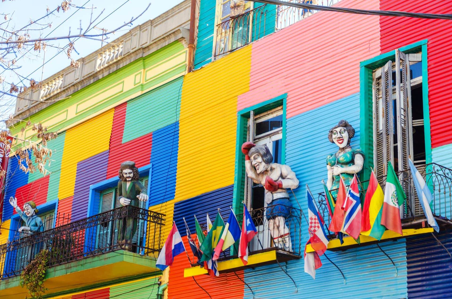 Argentinian district La Boca in Buenos Aires. There are bright buildings and figures outside
